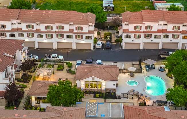 A large building with a pool in front of it.
