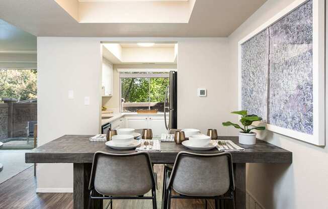 a kitchen and dining room with a table and chairs