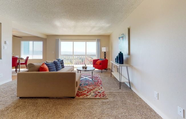 Renton WA Apartments for Rent - Sunset View Spacious Living Room with Floor to Ceiling Sliding Glass Door Leading to the Balcony