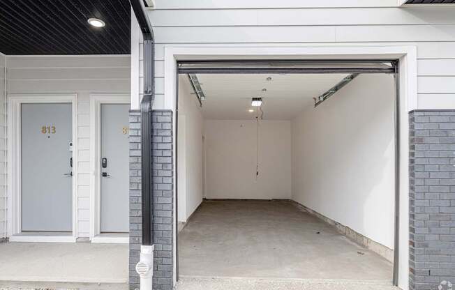 A white garage door with the number 813 on it.