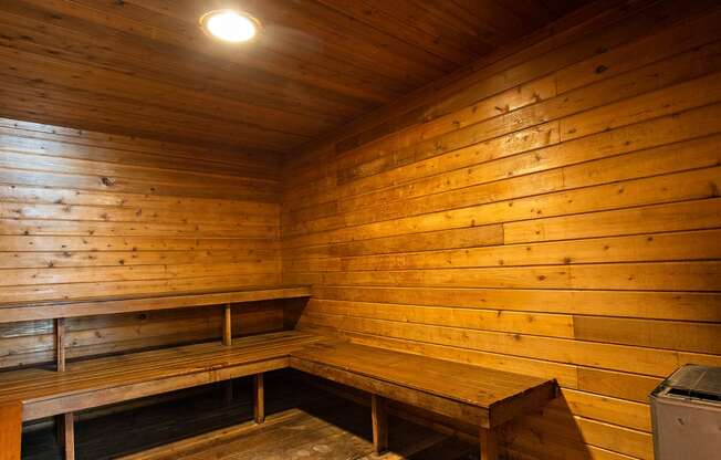 a small sauna with benches and a table