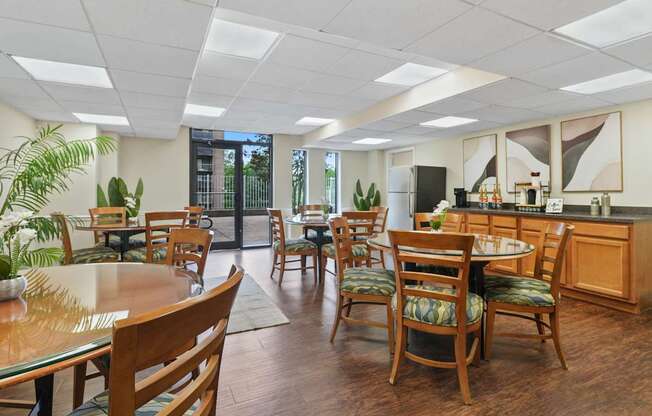 A kitchen and dining area with wooden chairs and tables.