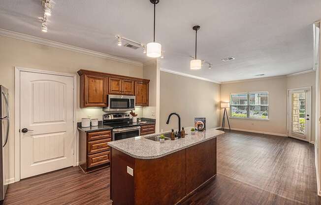 a kitchen with wooden cabinets and a granite counter top