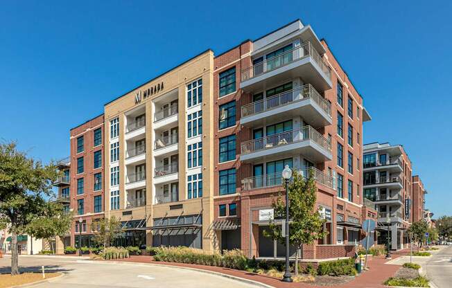 A large red brick building with the word "MANHATTAN" on the top.