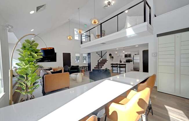 A modern interior with a white table and yellow chairs.