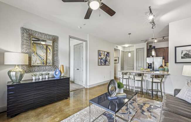 Elegant living area with stylish decor and modern furnishings at Allusion at West University apartments in Houston, TX