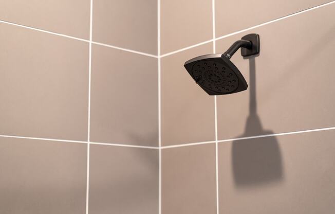 a close up of a shower head in a bathroom