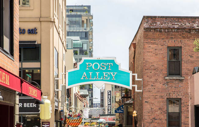 a city street sign that reads post alley