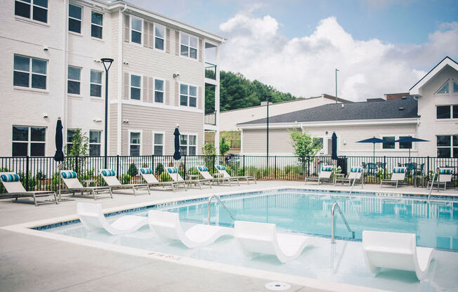 our apartments have a large pool with lounge chairs and umbrellas