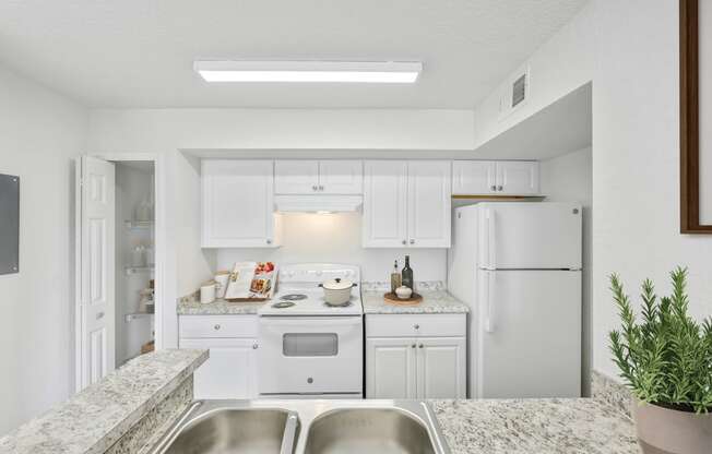 a kitchen with white cabinets and granite countertops