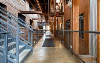 the interior of a building with stairs and metal railing