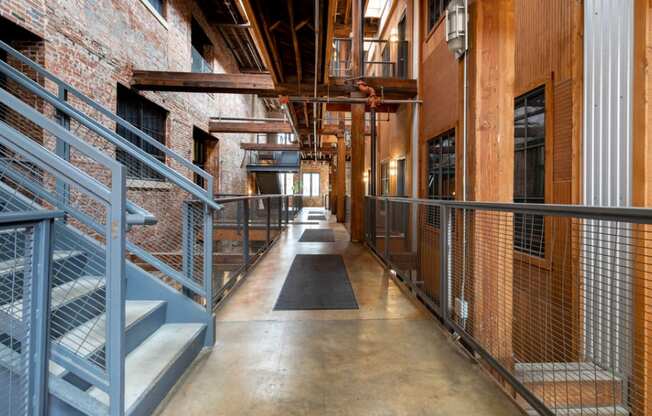 the interior of a building with stairs and metal railing