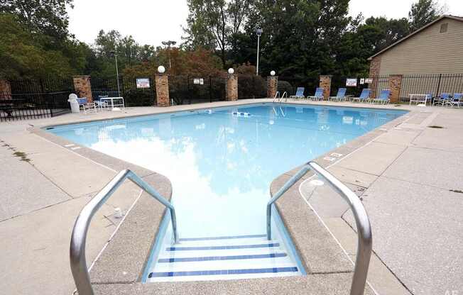A pool with a metal staircase leading down to it.