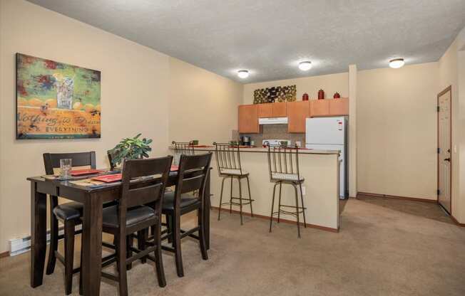 a kitchen with a bar and a dining table