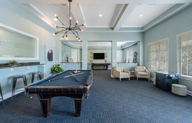 a large game room with a pool table