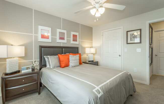 Spacious bedroom with plush carpeting and ceiling fan with lighting