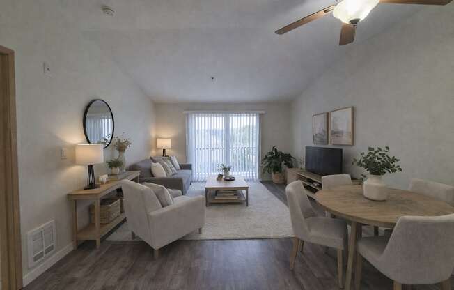 A living room with a grey couch, a wooden coffee table, and a television.