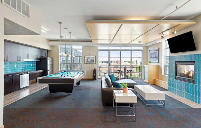 a lounge area with a pool table and television