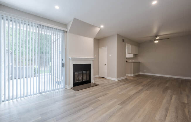 A room with a fireplace and wooden floors. at Harbor Pointe, Dana Point, California