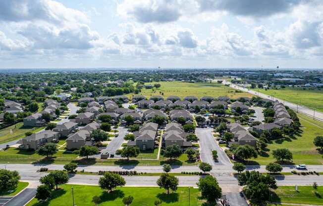 A suburban neighborhood with rows of houses and streets.