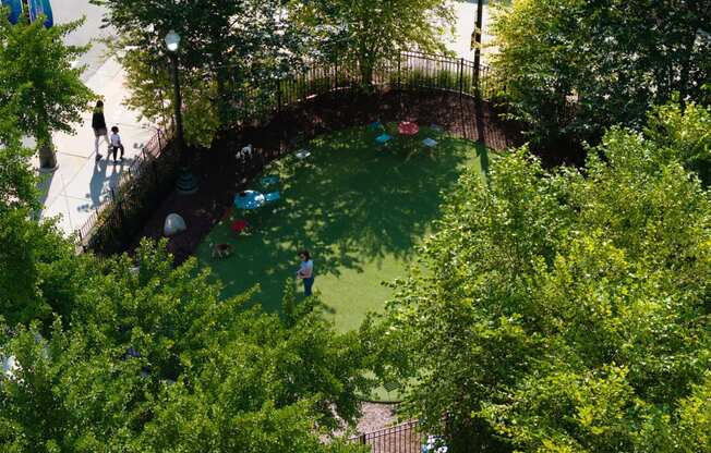 a birds eye view of a park with trees and people