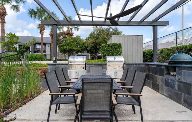 A patio with a table and chairs under a pergola.