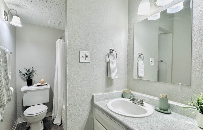Elegant bathroom featuring modern fixtures, soft lighting, and a stylish vanity, perfect for relaxation.