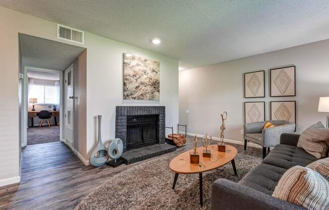 Living room with a fireplace and a table  at Union Heights Apartments, Colorado Springs, CO