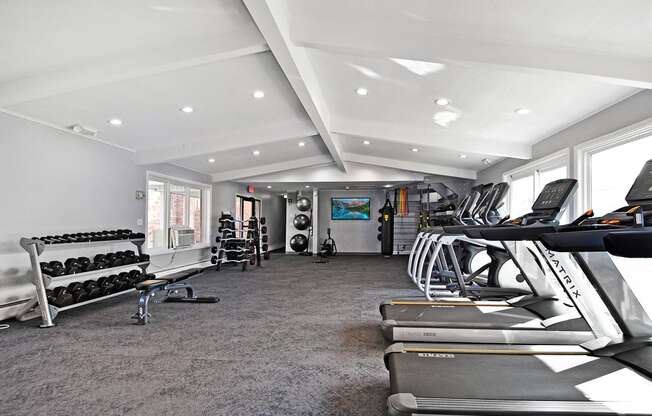 fitness center with cardio equipment and free weights