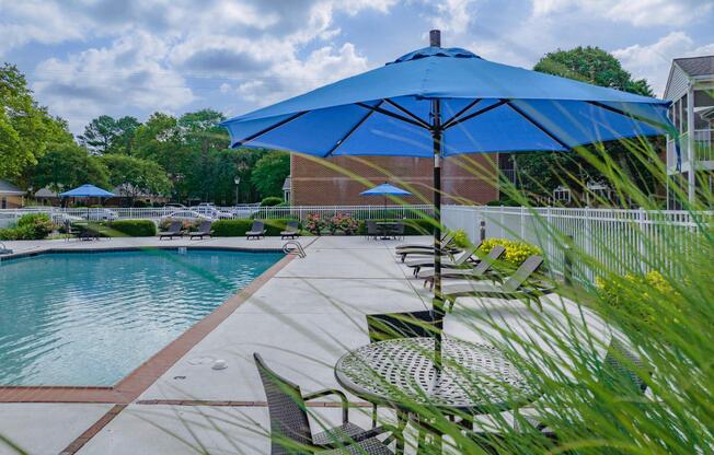 a body of water with a colorful umbrella