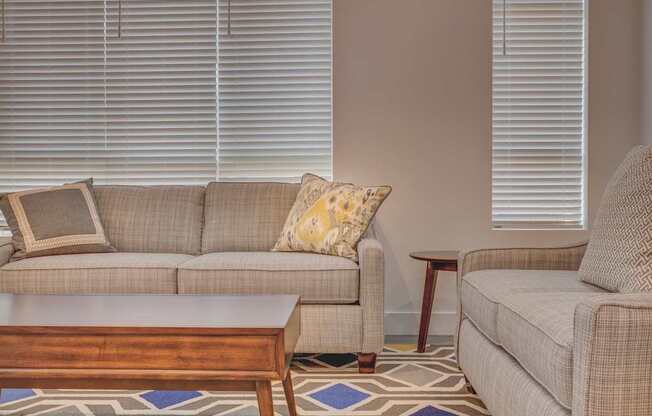 A living room with a couch, chair, and coffee table.