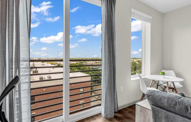 a living room with sliding glass doors and a balcony with a view