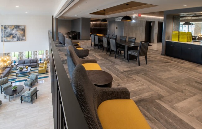 a lobby of a hotel with chairs and tables