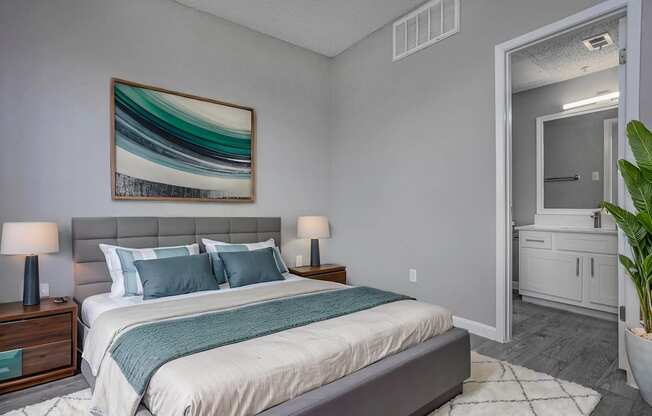 a bedroom with grey walls and a white bed