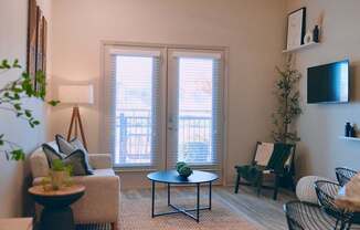 A living room with a couch, chair, and table.