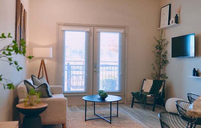 A living room with a couch, chair, and table.