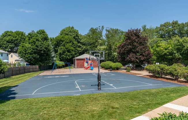 Towne estates apartments in Melrose offeres a playground and basketball court with grilling areas