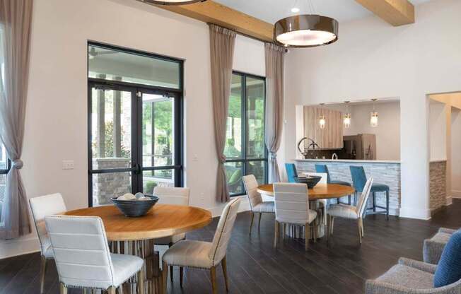 A modern dining room with a round table and chairs.