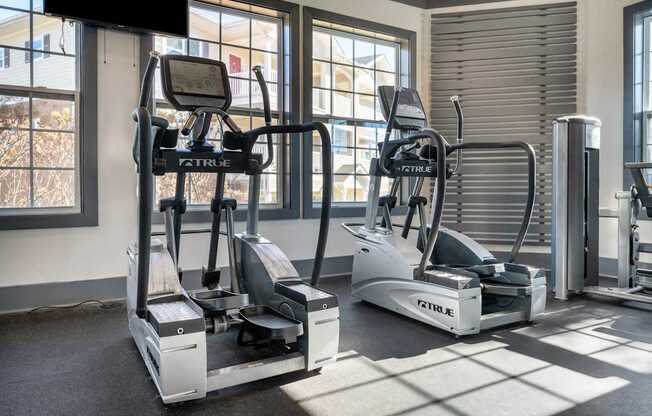 A gym with treadmills and elliptical machines.