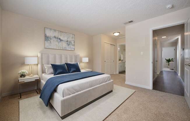 a bedroom with a white bed and blue pillows