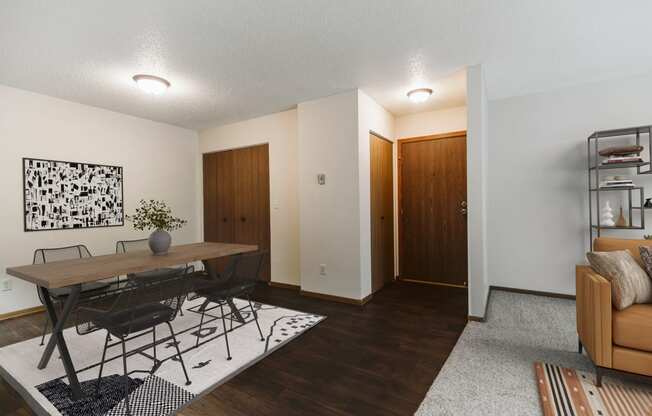 A dining room with a table and four chairs and the entry door in the background  at Harrison and Richfield, Grand Forks, North Dakota