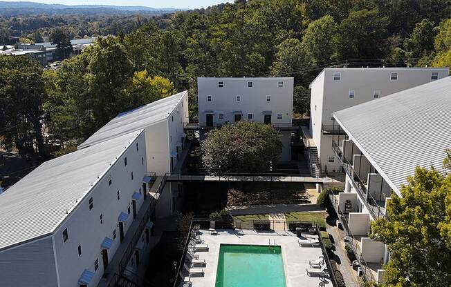 arial view of a building with a pool in the middle