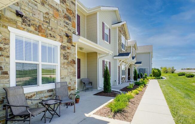 a row of apartment entrances with landscaping