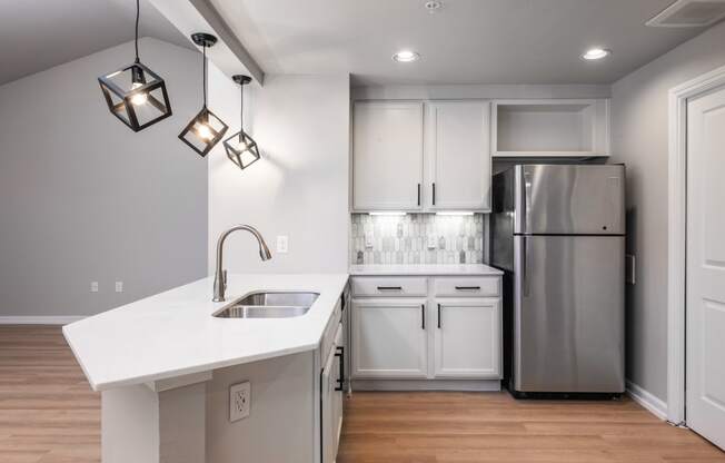 a kitchen with white cabinets and a white counter top