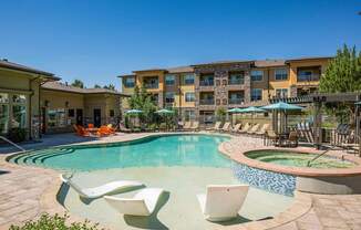 Resort-inspired swimming pool with tanning ledge - Acadia at Cornerstar Apartments