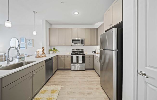 a large kitchen with stainless steel appliances and a sink