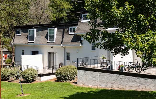a white house with a deck and a yard