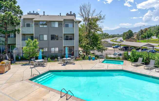 Swimming pool and a patio with chairs  at Union Heights Apartments, Colorado Springs, CO