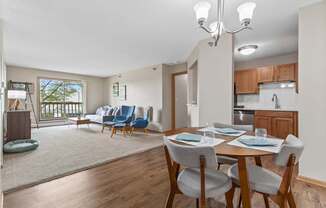 A dining room with a table set for four.