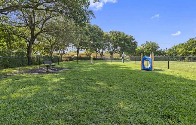 a park with a playground and a target on the grass